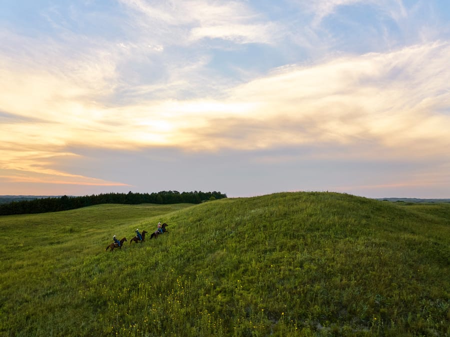 Calamus Outfitters_Horseback riders in Grassland at Sunset_Clay Cook Shoot 2024