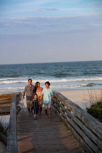 Family walking on boardwalk in New Smyrna Beach