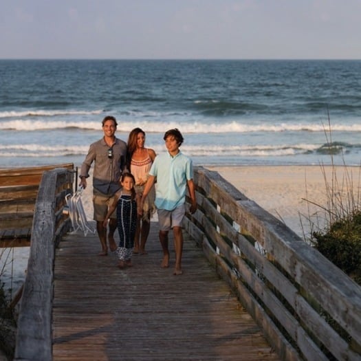 Family walking on boardwalk in New Smyrna Beach