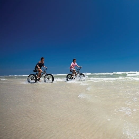 Mom and son riding beach cruisers in New Smyrna Beach