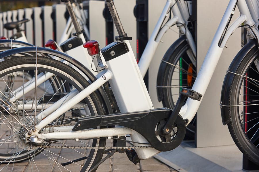 Urban electric bikes charging batteries in the city. Transportation