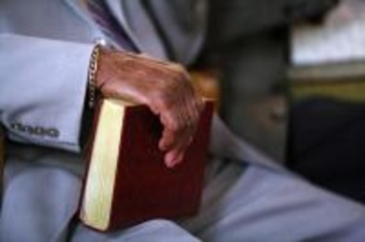 man_s_hand_on_bible_2001