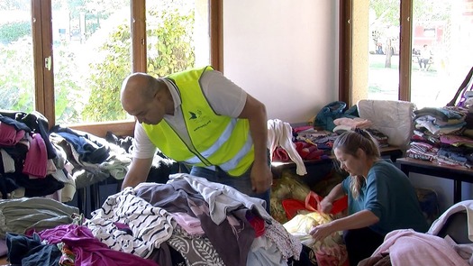 PRINT volunteers sorting clothes for refugees at recreation center outside Paris