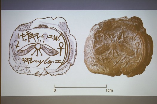 A projected image of a clay imprint, which was unearthed from excavations near Jerusalem's Old City, is displayed during a news conference at Hebrew Uni