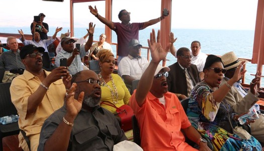 web Members of the Church of God in Christ denomination pray during a boat ride on Israel's Sea of Galilee with the International Fellowship of Christians and Jews last summer.