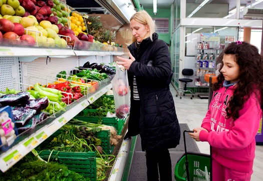 Argiro and her daughter, Eleni, shopping for vegetables at a Baazar supermarket in Kalithea.
Argiro and her family are  members of the free vegetable and milk program which is funded by IOCC.