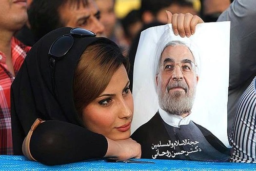 Iranian woman holding up Rouhani sign