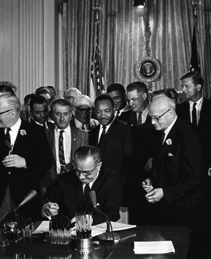 Martin Luther King standing over LBJ Signing Civil Rights Bill 1964 copy