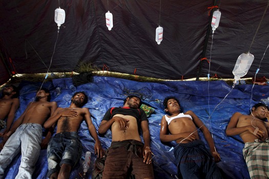 Rohingya and Bangladeshi migrants who arrived in Indonesia by boat receive medical assistance at an aid station in Kuala Langsa in Indonesia's Aceh Province