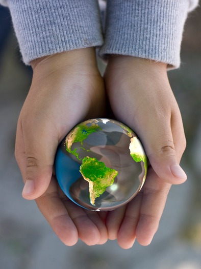 a child holds a globe, computer generated image, mapping image from NASA