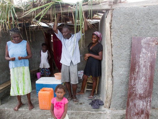 PRINT A family discusses their needs in the coastal town of Gomier.