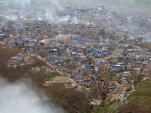 PRINT Tarps cover homes that lost roofs in Jeremie on October 12, 2016.