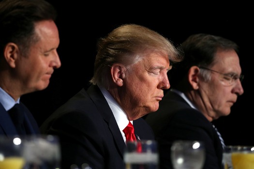 PRINT U.S. President Donald Trump prays during the National Prayer Breakfast event in Washington, U.S.