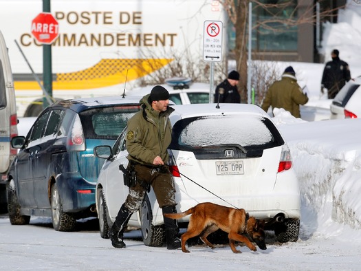 PRINT Police officers patrol the perimeter at the scene of a fatal shooting at the Quebec Islamic Cultural Centre in Quebec City