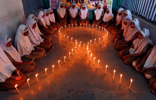 PRINT School girls light candles in the shape of a ribbon during a HIV/AIDS awareness campaign ahead of World Aids Day, in Ahmedabad