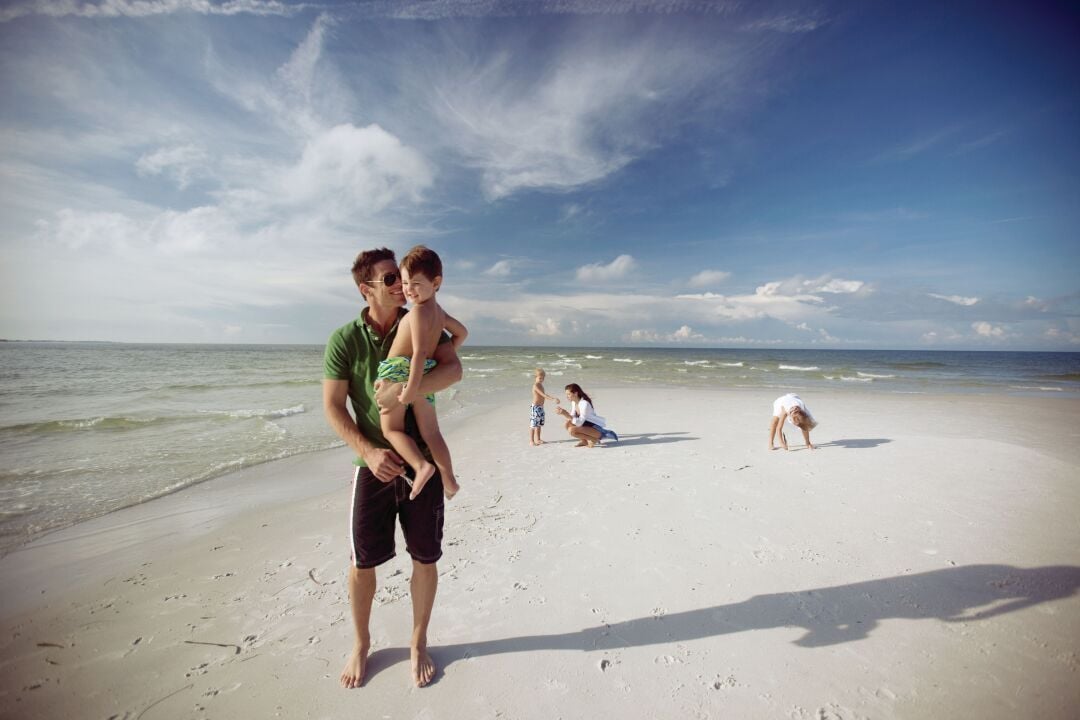 Dad, boy and family in background in AMI