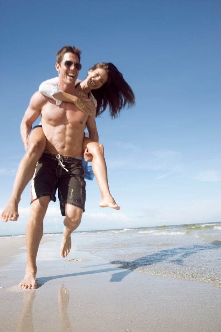 PLAYFUL COUPLE ON SANDBAR ON AMI