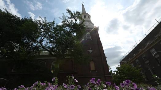 Christ Church pan from below with steeple and flowers