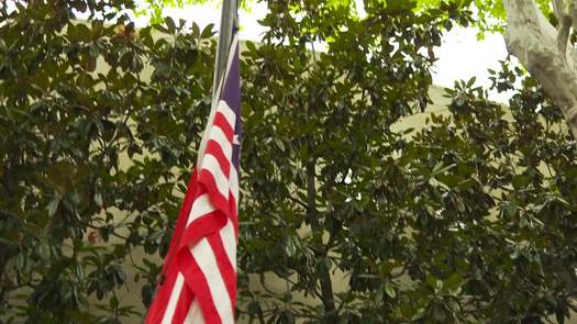 Betsy Ross House, colonial character raising flags