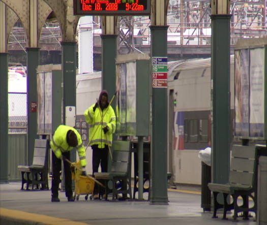 Workers cleaning train platform at 30th Street Station