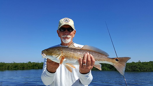 Man with Redfish Chase N Tails