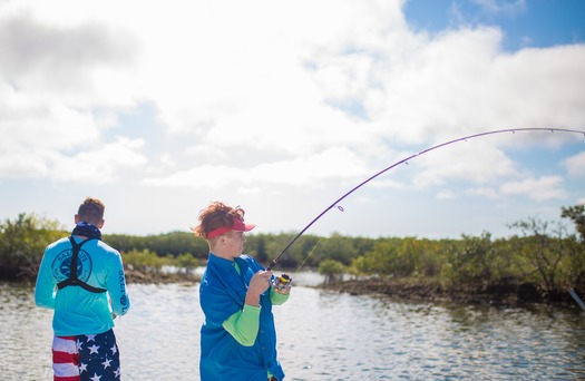 Ms. Kim and Son fishing with friends