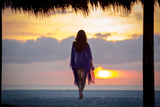 Sunset Woman Walking on Beach under Cabana