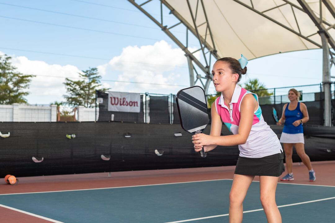 Child playing Pickleball at East Naples Community Park