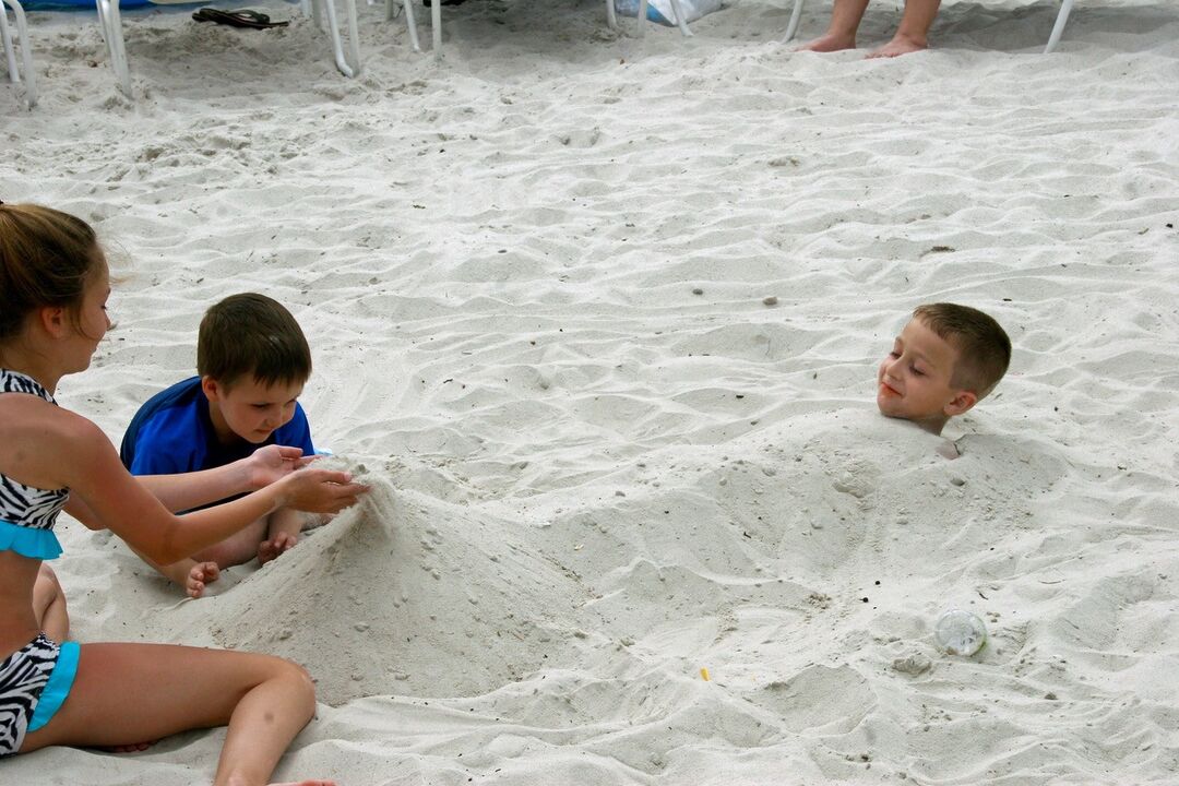 Buc Bay kids playing in sand