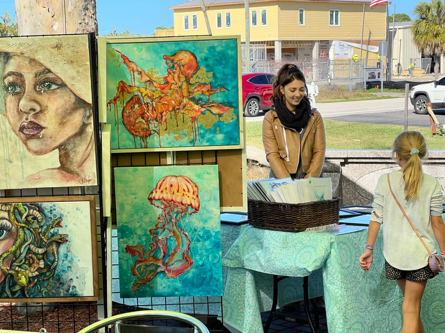 Renata with art and young girl in booth - HB Artwalk