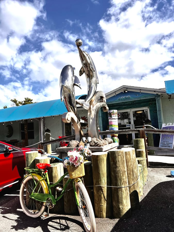 Silver Dolphin Statue with bike